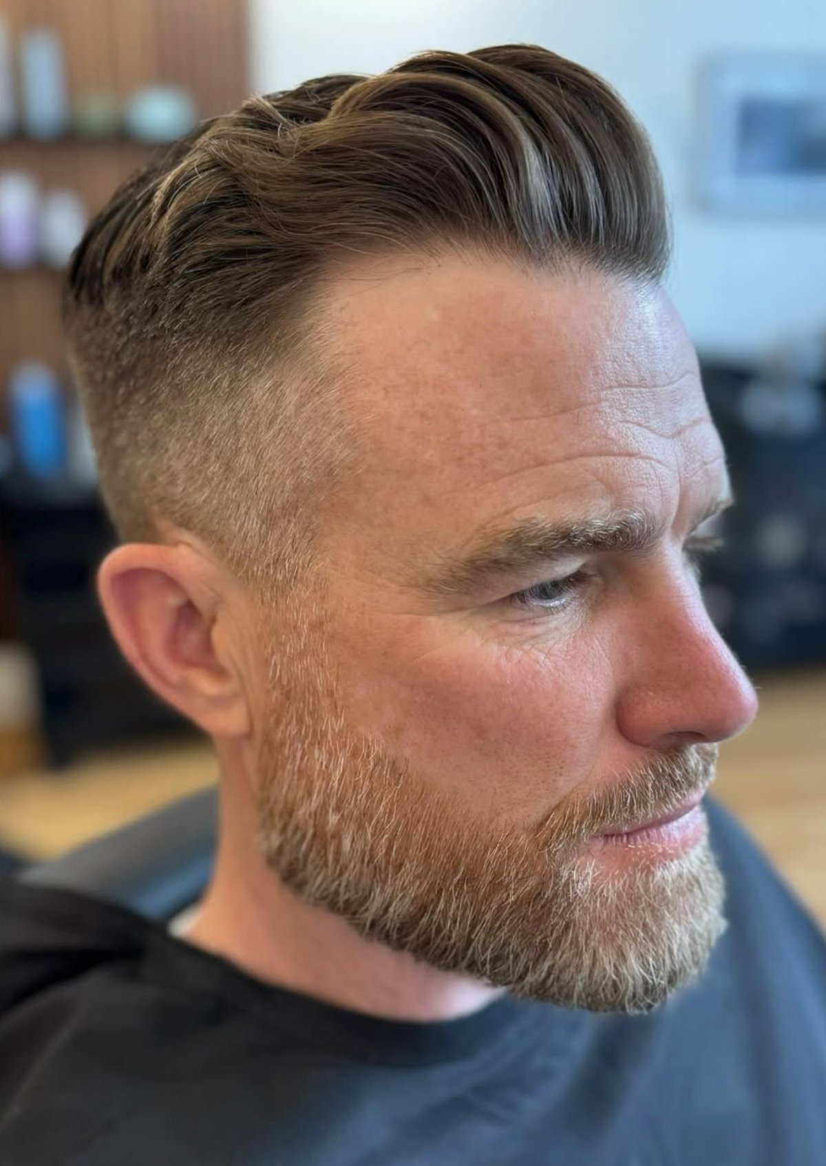 Finished men's haircut — short tapered cut with moustache
