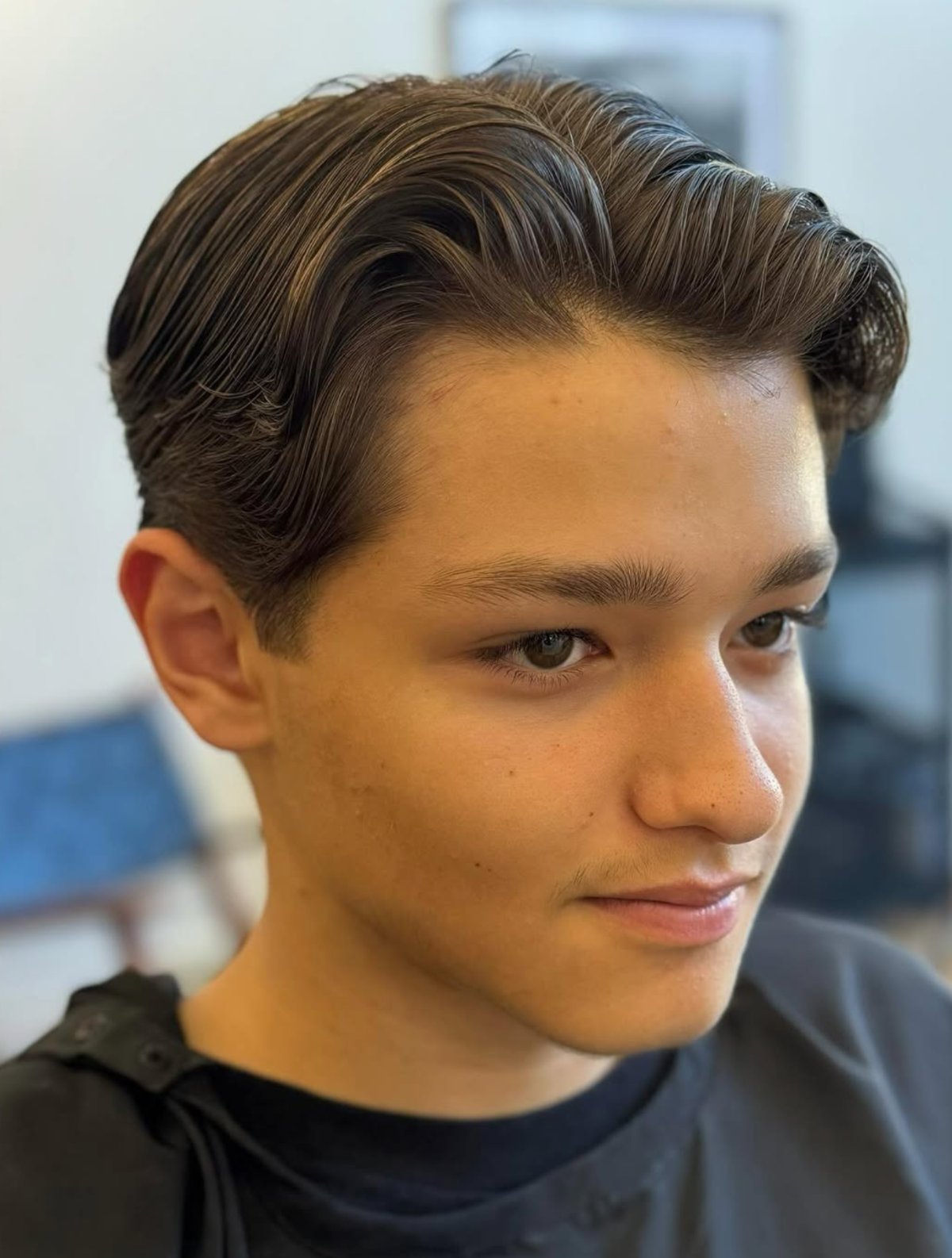 Finished men's haircut — slicked-back undercut with a groomed beard